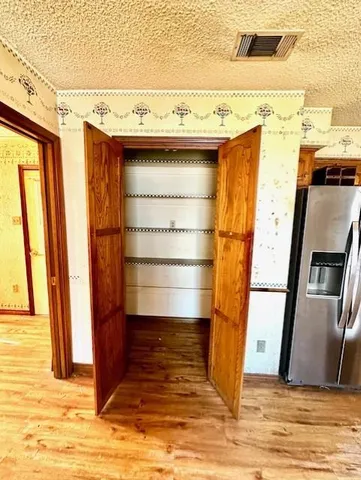 a view of walk in closet with an empty space