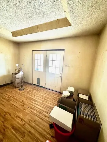 a living room with a couch and wooden floor