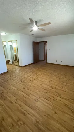 a view of a room with wooden floor