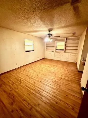 a view of a room with wooden floor