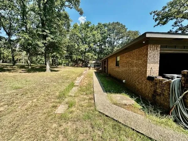 a backyard of a house with yard and trampoline