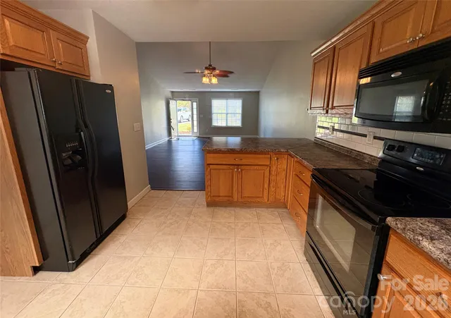 a kitchen with stainless steel appliances granite countertop a refrigerator stove and sink