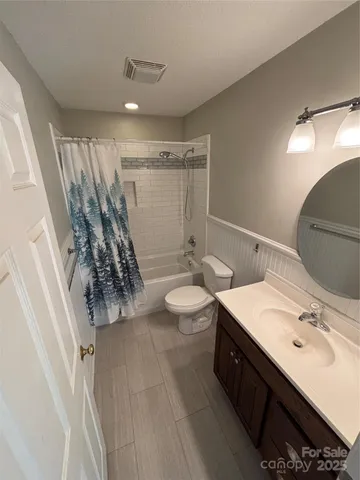 a bathroom with a double vanity sink mirror and toilet