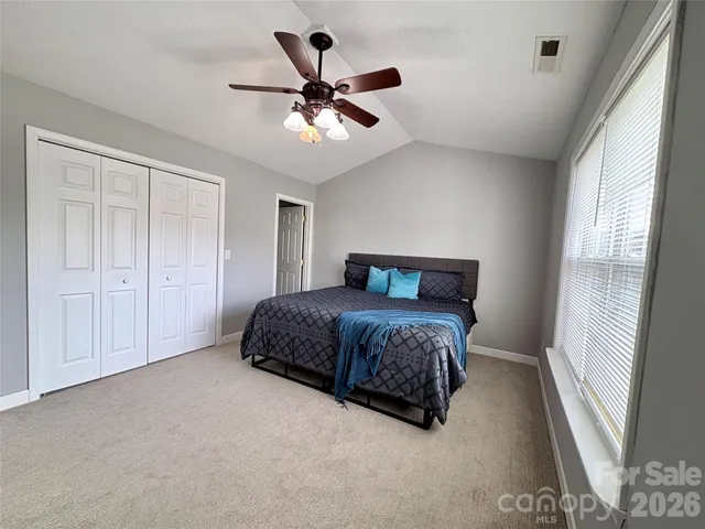 a bedroom with a bed and a large window