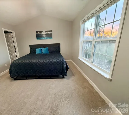 a bedroom with a large bed and a large window