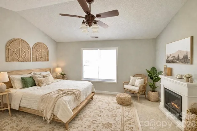 a bedroom with a bed a couch and potted plant