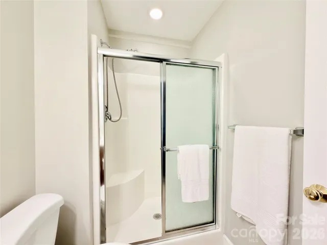 a bathroom with a glass shower door