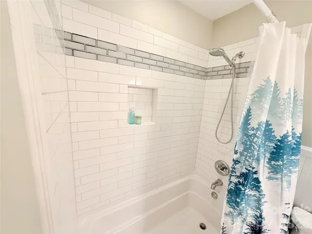 a bathroom with a shower curtain and a bathtub