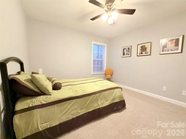 a bed sitting in a bedroom next to a window