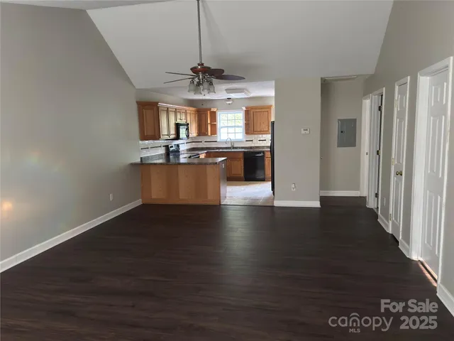 a view of a room with wooden floor chandelier and entryway