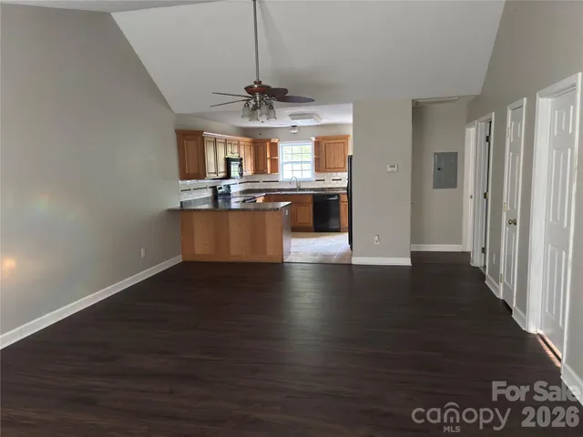 a view of a room with wooden floor chandelier and entryway