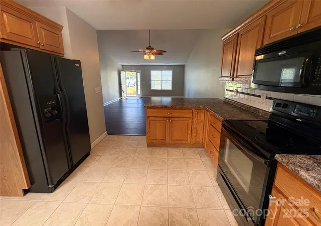 a kitchen with stainless steel appliances granite countertop a refrigerator stove and sink