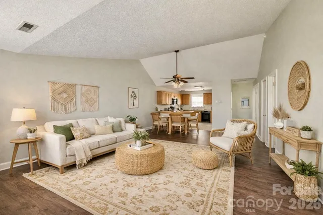 a living room with furniture a rug and a chandelier