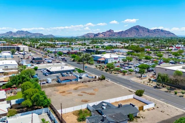 an aerial view of residential houses with yard