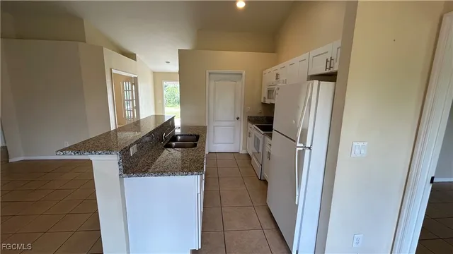 a kitchen with a refrigerator and a sink