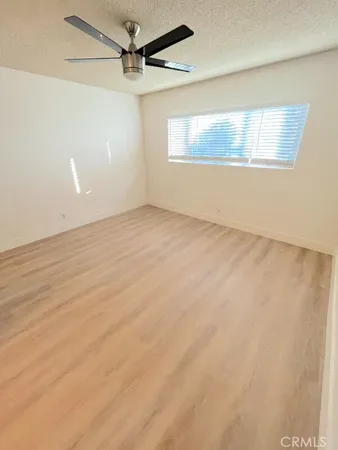 a view of a hallway with wooden floor and entryway