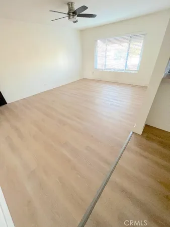 a view of a kitchen with a sink a microwave and cabinets