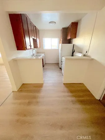 a kitchen with stainless steel appliances granite countertop a sink and a stove top oven