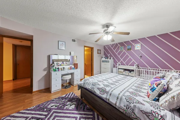 a bedroom with a bed and a chandelier