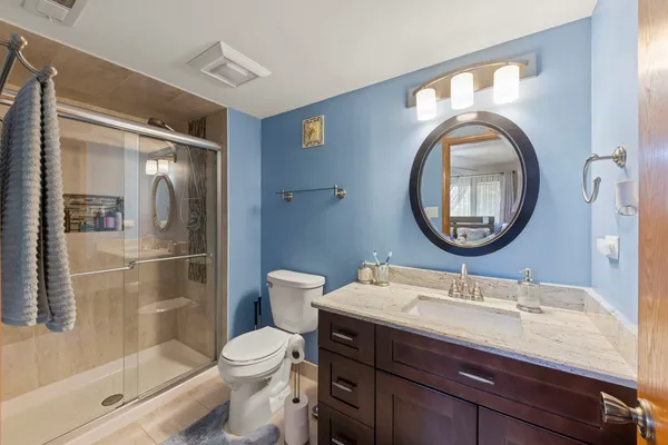 a bathroom with a toilet a sink and a mirror