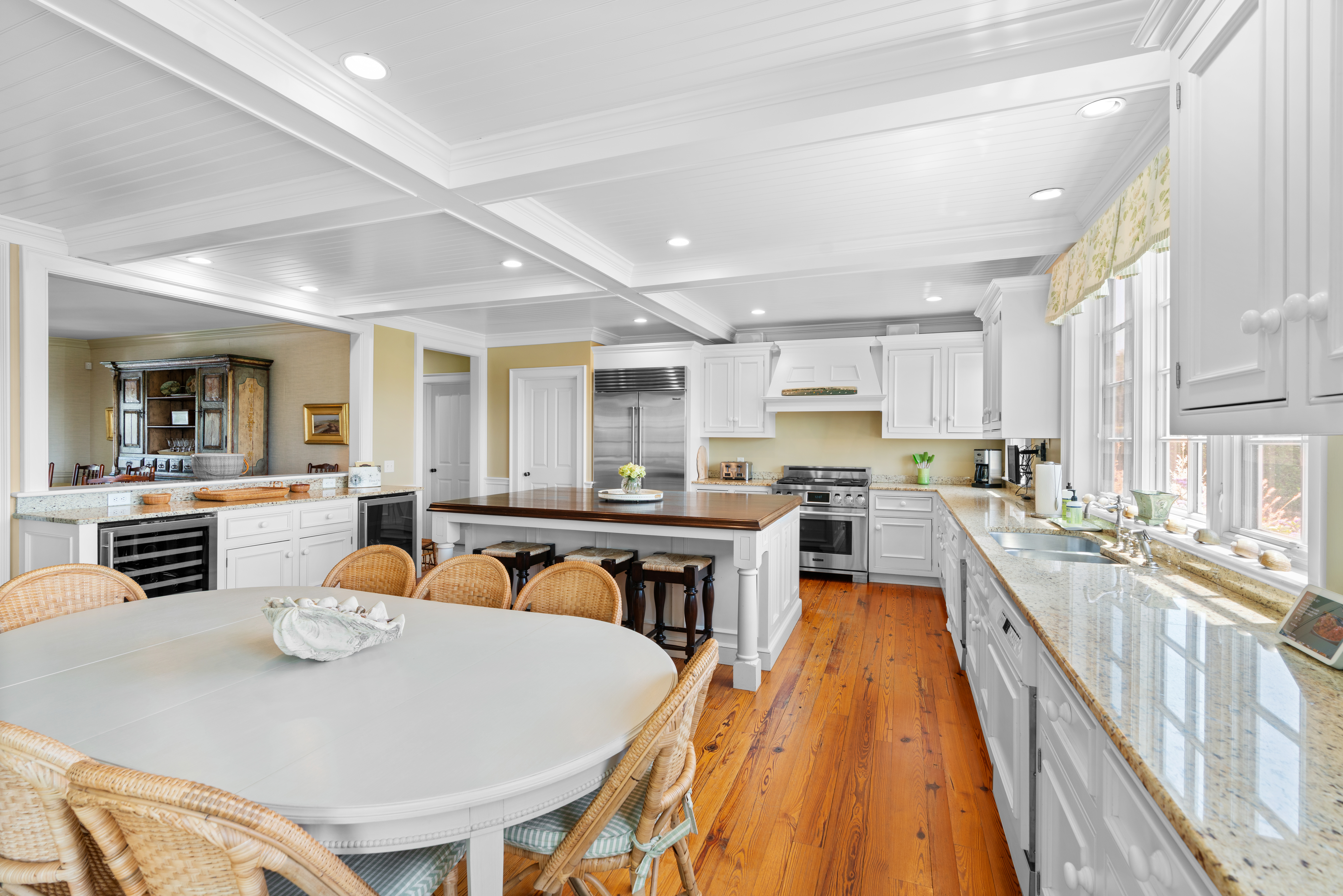 42 Main Street Nantucket, MA 02554 - Photo 11 of 40 a kitchen with stainless steel appliances granite countertop a kitchen island a stove a sink a dining table and chairs