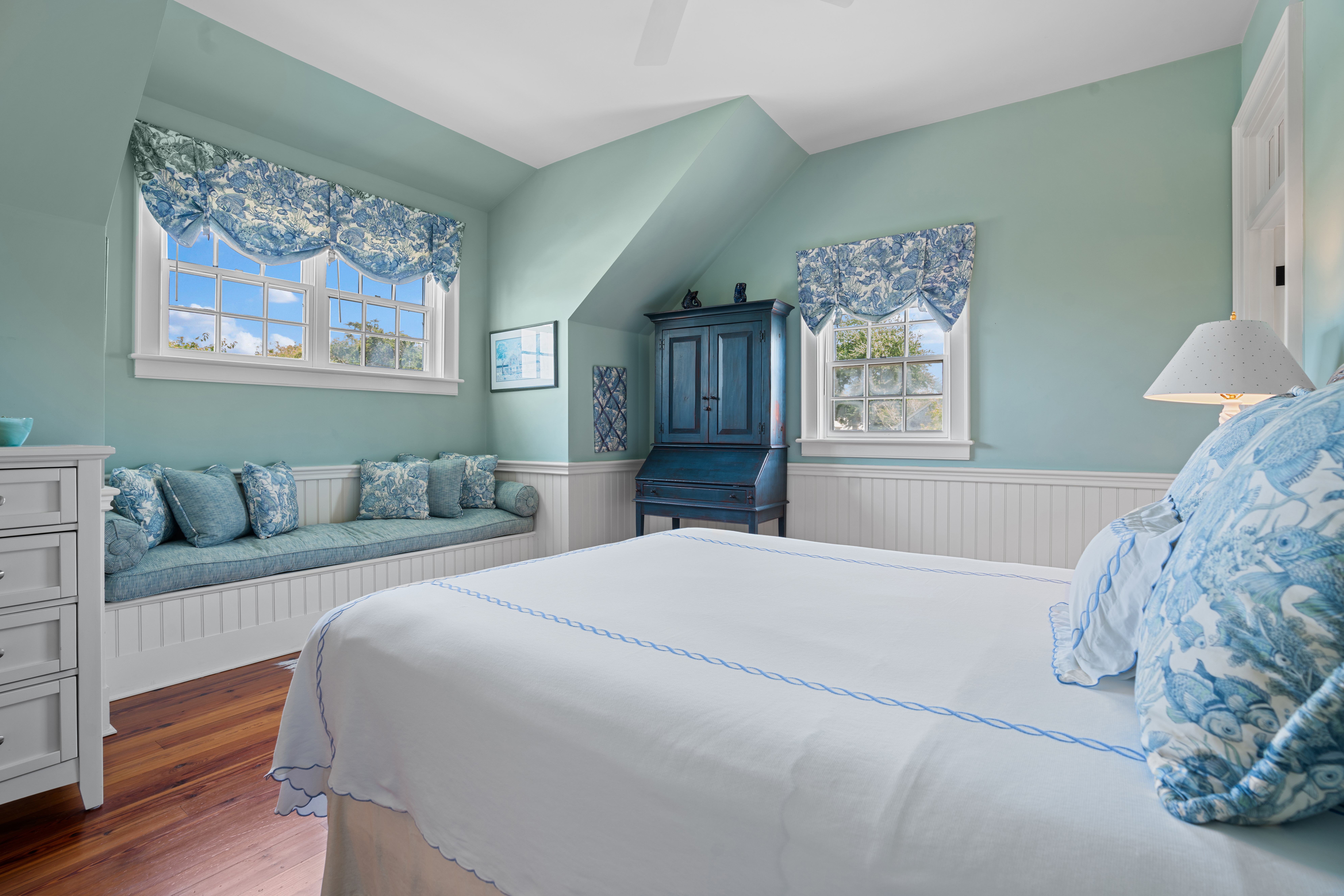 42 Main Street Nantucket, MA 02554 - Photo 22 of 40 a bedroom with a large bed and a chandelier