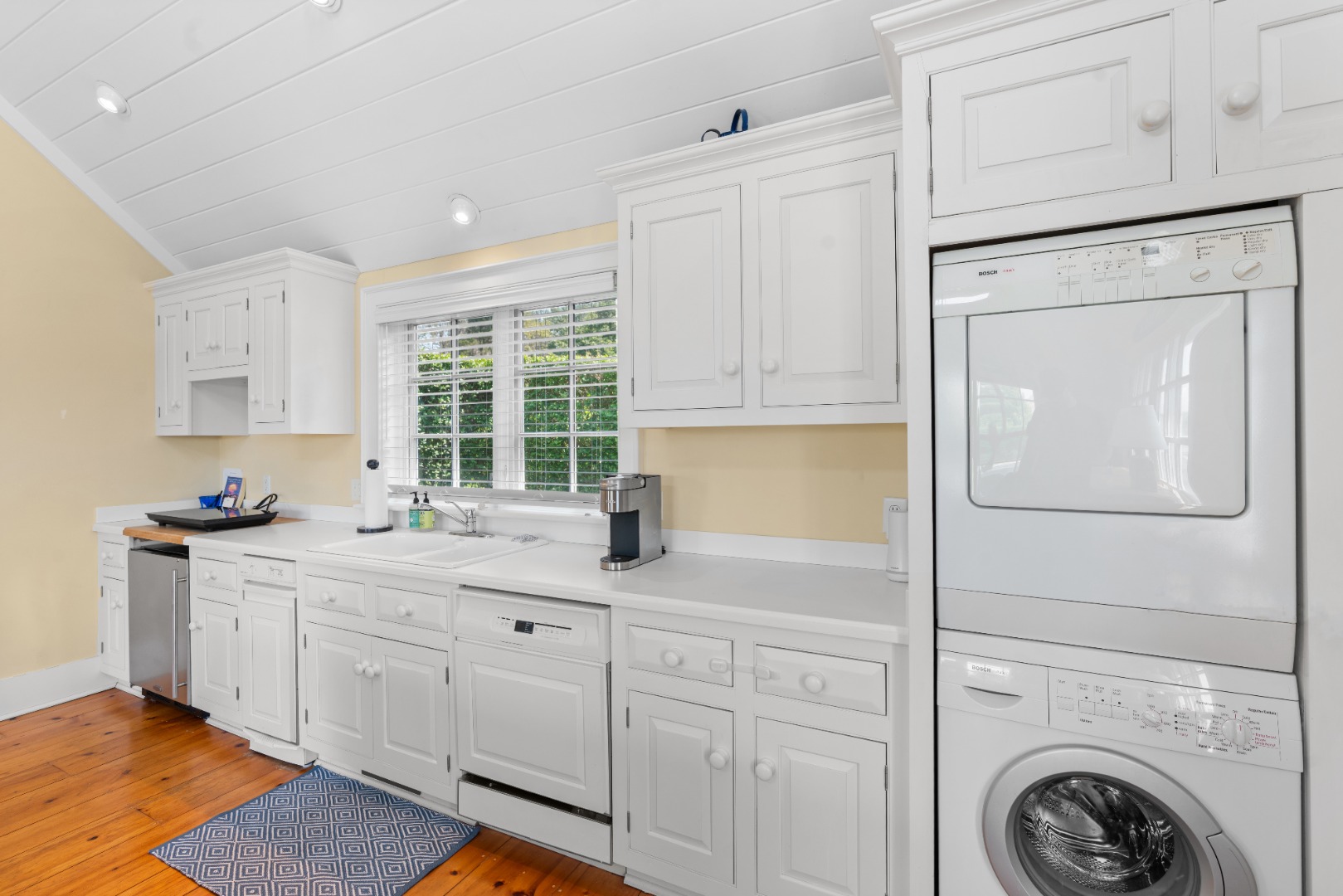 42 Main Street Nantucket, MA 02554 - Photo 34 of 40 a kitchen with white cabinets and sink