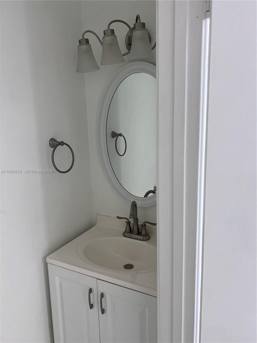 2750 West 76th Street, Unit 208 Hialeah, FL 33016 - Photo 5 of 10 a bathroom with a sink and mirror