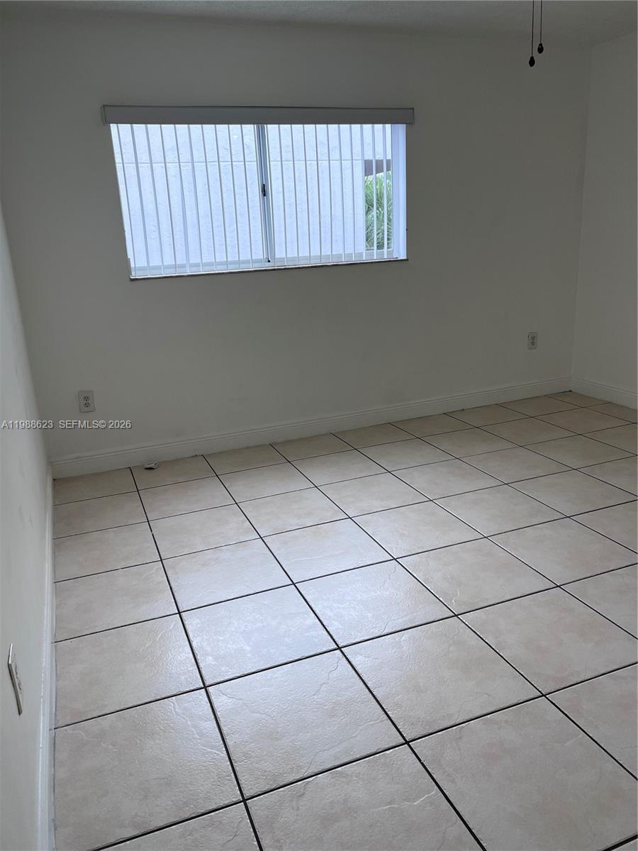 2750 West 76th Street, Unit 208 Hialeah, FL 33016 - Photo 6 of 10 a view of a livingroom with an empty space and a window