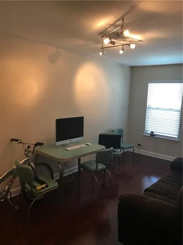 a view of a workspace with furniture and chandelier