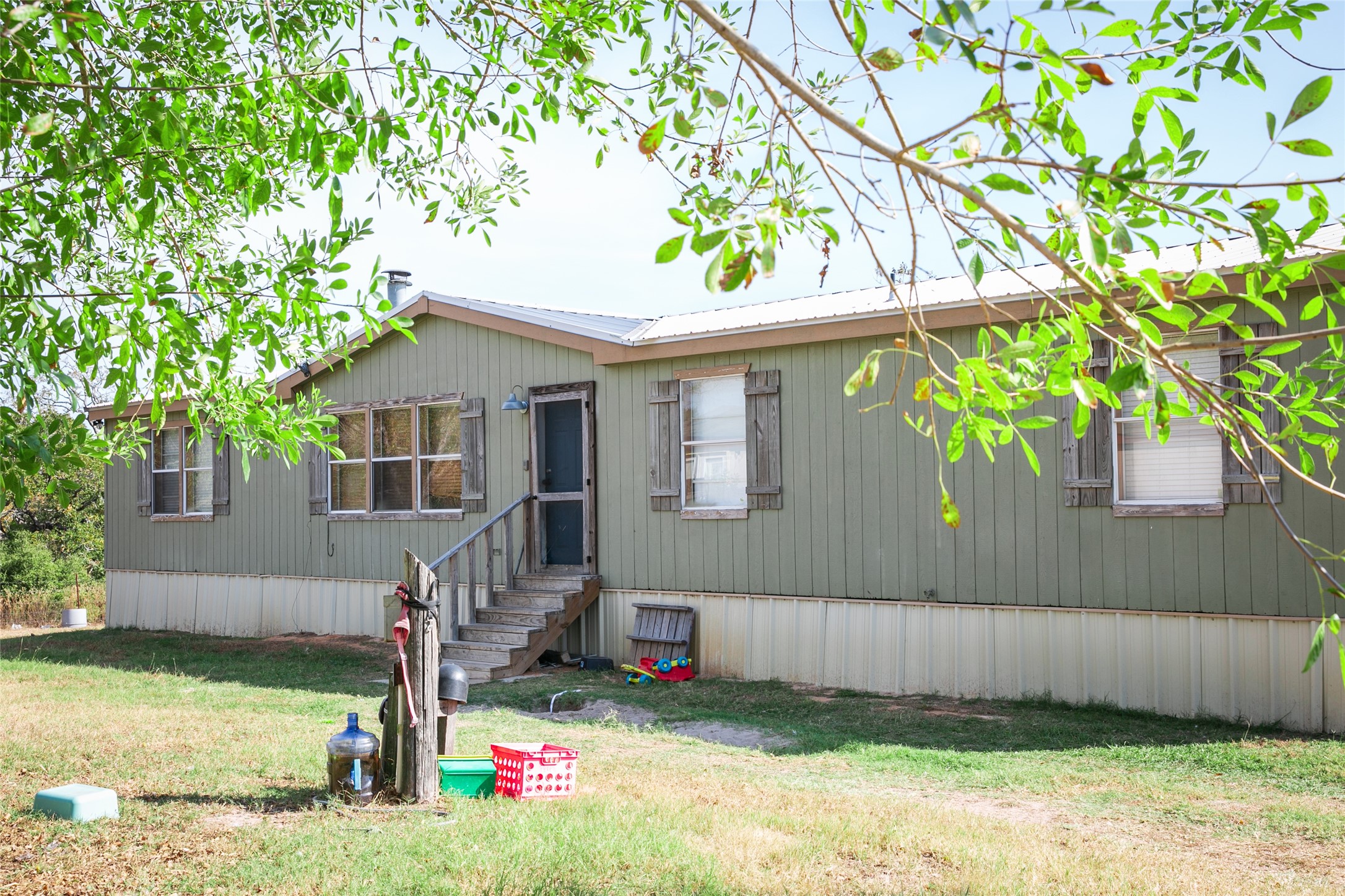 4254 FM 180 Road Ledbetter, TX 78946 - Photo 7 of 17 a front view of a house with a yard