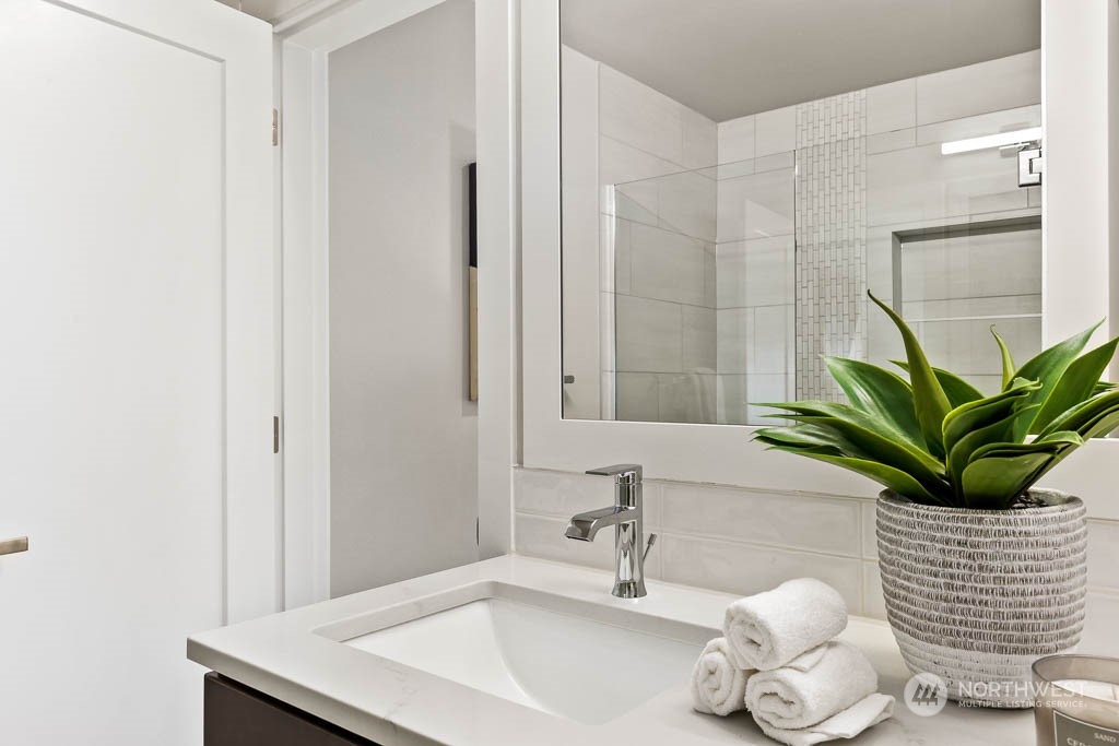 825 238th Place Southeast, Unit B8 Bothell, WA 98021 - Photo 25 of 32 a bathroom with a sink a mirror and a potted plant