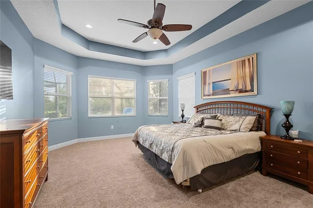 a bathroom with a granite countertop sink a toilet a mirror and shower curtain