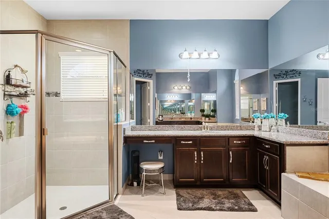 a kitchen with stainless steel appliances kitchen island granite countertop a kitchen island and chairs in it