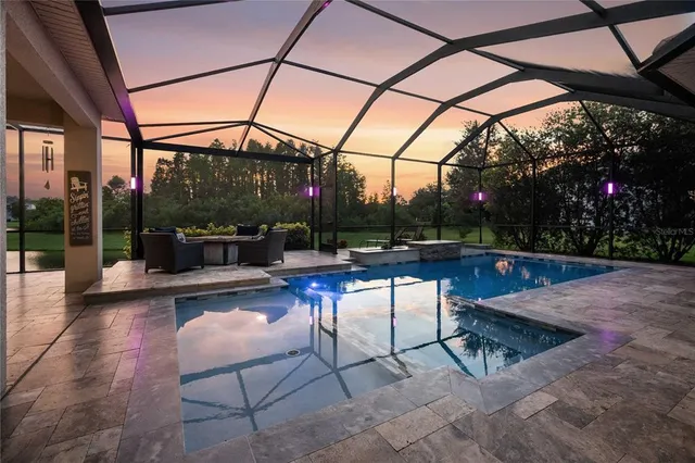 a view of a roof deck with table and chairs under an umbrella