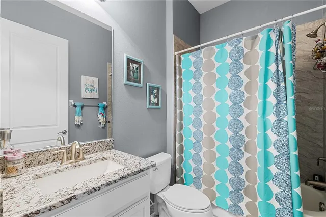 a kitchen with stainless steel appliances granite countertop a sink a stove and a wooden cabinets