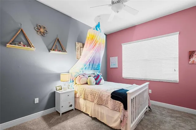a living room with furniture ceiling fan and a window
