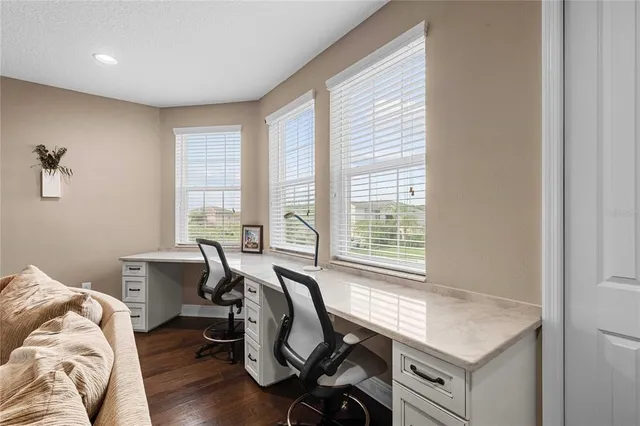 a room with pool table and glass windows
