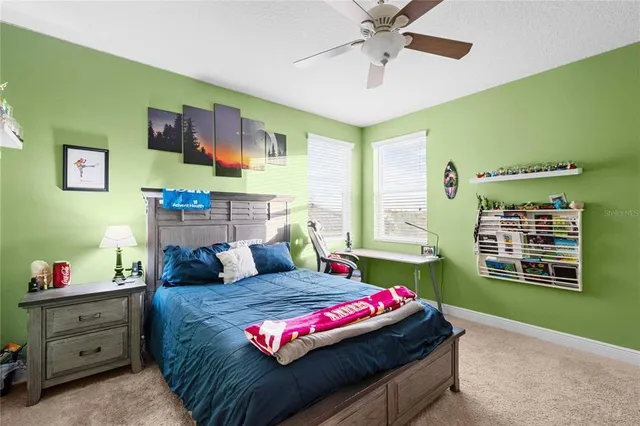 a living room with stainless steel appliances kitchen island granite countertop a sink and cabinets