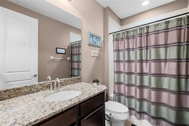 an aerial view of residential houses with outdoor space and swimming pool