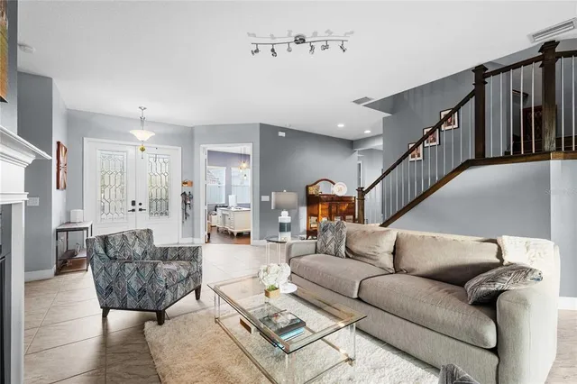 a living room with furniture fireplace and a large window