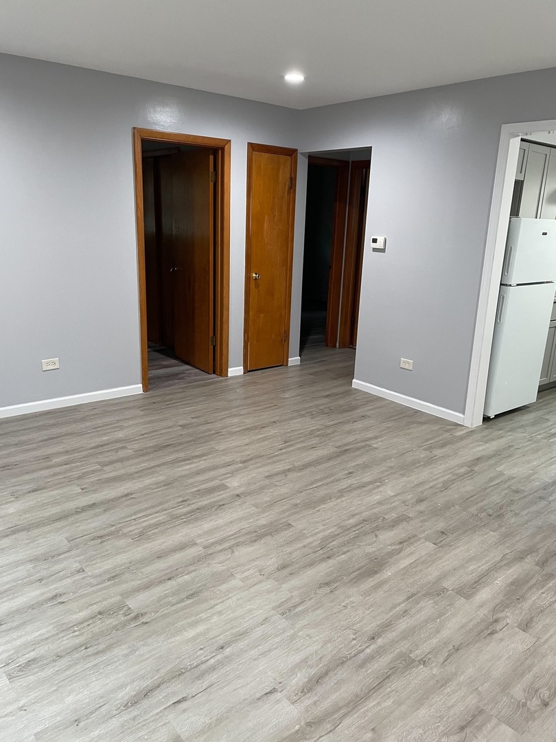 2290 182nd Place Lansing, IL 60438 - Photo 12 of 23 an empty room with wooden floor and closet