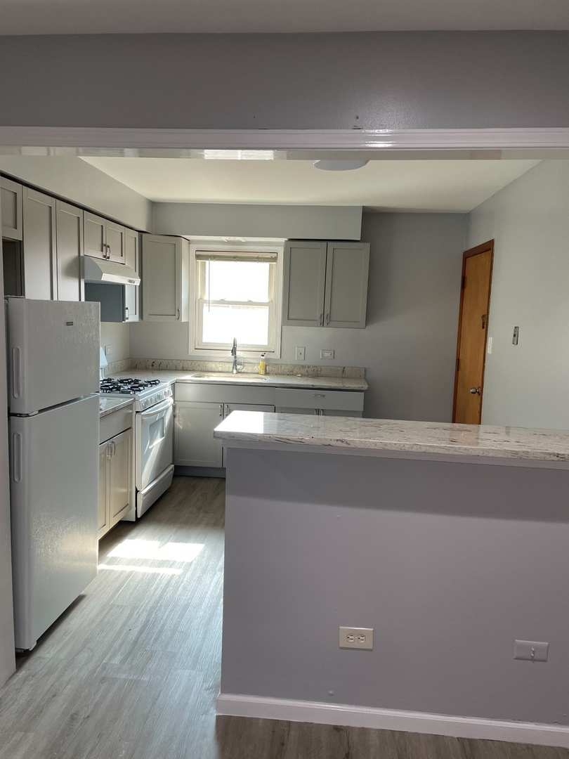 2290 182nd Place Lansing, IL 60438 - Photo 14 of 23 a kitchen with stainless steel appliances a refrigerator sink and cabinets