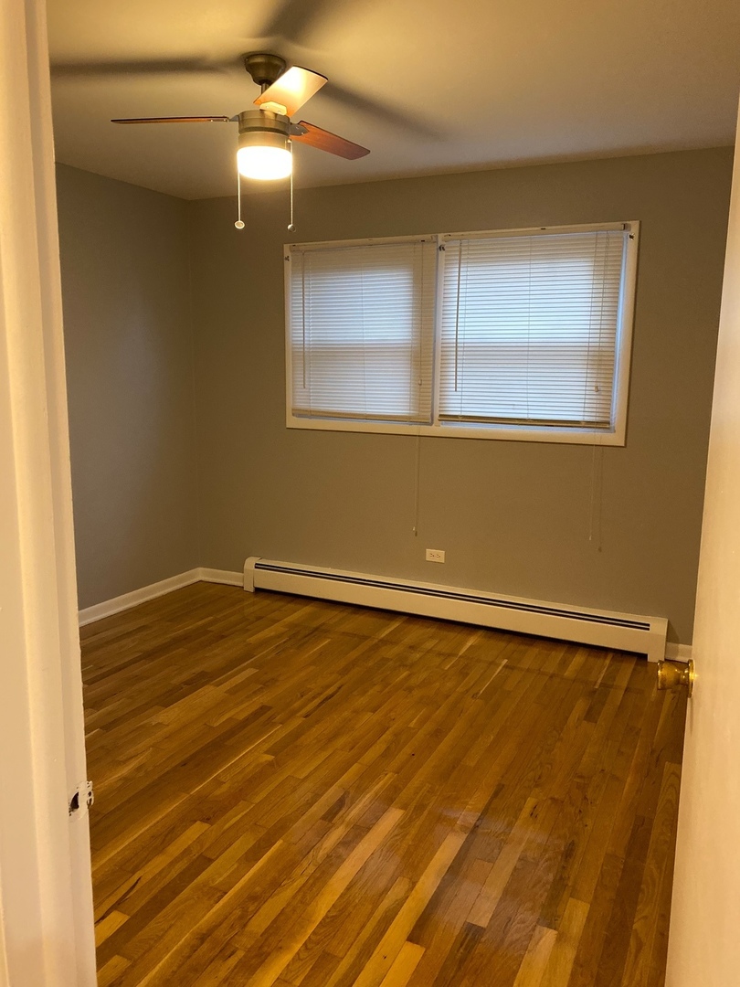 2290 182nd Place Lansing, IL 60438 - Photo 17 of 23 a view of an empty room with window and wooden floor