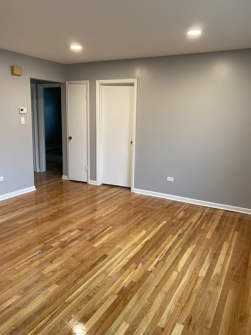 2290 182nd Place Lansing, IL 60438 - Photo 18 of 23 an empty room with wooden floor and bathroom view