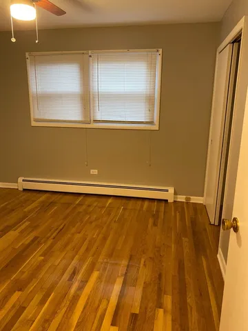 a view of a room with wooden floor and windows