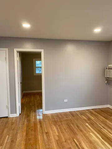 an empty room with wooden floor and closet