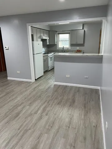 a view of a kitchen with a sink and dishwasher wooden floor