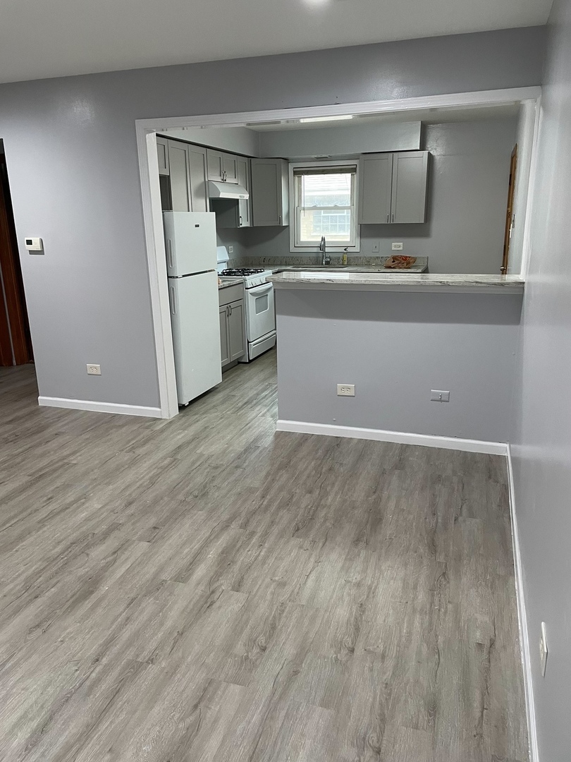 2290 182nd Place Lansing, IL 60438 - Photo 4 of 23 a view of a kitchen with a sink and dishwasher wooden floor