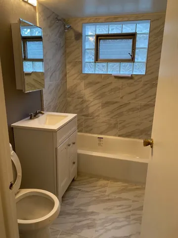 a bathroom with a sink a toilet and mirror